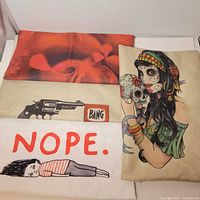 Four pillow covers laid flat showing each novelty design