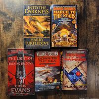 Overview of all five paperback novels on tabletop