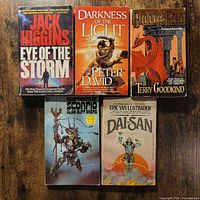 front covers of five paperback novels