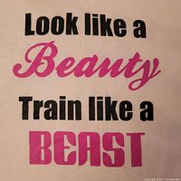 Close-up of vinyl text "Look like a Beauty Train like a Beast"