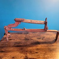 Full view of brick carrier showing iron frame and wooden handle