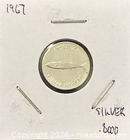 Reverse of 1967 10-cent coin showing mackerel design in holder