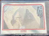 Front of trading card in sleeve showing scene and title