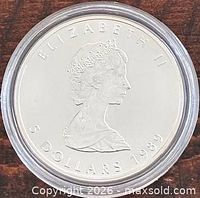 Obverse showing Queen Elizabeth II portrait, year 1989, denomination 5 Dollars, coin in capsule