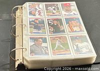 Binder of card pages showing nine cards per page