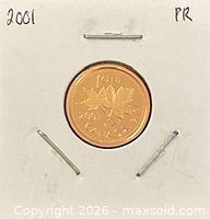 Coin in holder, reverse side showing maple leaf design and 2001 date