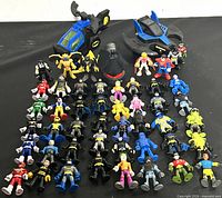 Full lot of Imaginext figures arranged in rows with two Bat vehicles
