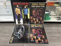 All five sealed Star Trek posters displayed; two vertical Original Series character posters and three Deep Space Nine posters