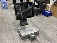 Front angled view showing touchscreen, weighing platform and control panel