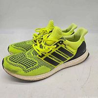 Lateral side view of both shoes showing uppers, midsoles, laces, and overall condition