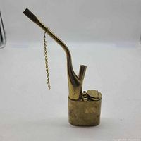 Full view of brass water pipe showing stem, base and chain