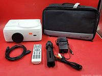 All items: projector, case, tripod, remote, HDMI cable, power adapter, RCA cable