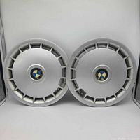 Front view of both BMW hub caps showing emblems and vented design