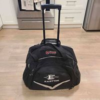 Front view of black Easton wheeled sports bag with handle extended