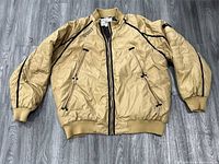 Front view of tan G-Unit quilted bomber jacket showing full design and condition