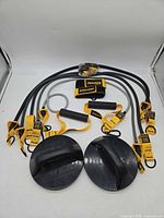 Full lot showing five resistance bands with yellow strap ends, foam grips, door anchor and two black rotating push-up handles