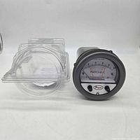 Front view of Dwyer Photohelic gauge removed from clamshell packaging