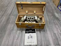 Open case showing stereoscope and manual