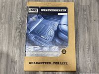 Boxed Husky Liners Weatherbeater floor mats showing product image and branding