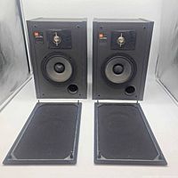 Full view of both JBL J216 PRO speakers with grilles removed and grilles placed in front