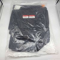 Sealed Kia package containing stacked black carpet mats