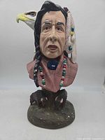 Front view of ceramic Indigenous bust with eagle and bears
