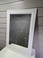 Front view of white framed mirror