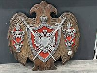 Front view showing full design and materials of coat of arms plaque