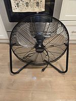 Front view of black 18-inch Mastercraft metal floor fan on stand