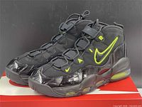 Side view of both sneakers on box showing uppers, soles, colorway and condition