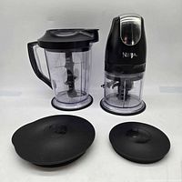 Full set showing motor head on 16-oz bowl, 48-oz pitcher, two storage lids