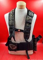 Front view of NXe camouflage tactical vest on mannequin