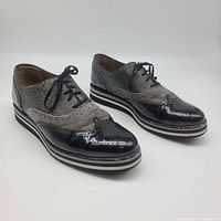 Full view of both shoes angled right showing uppers, laces, toe condition, platform sole