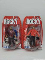 Front view of sealed Rocky Paulie and Mick action figures on blister cards