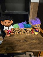 Front view of five Russ troll dolls showing sizes, clothing and hair colours