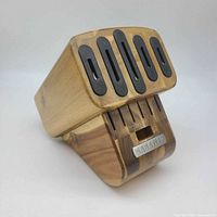 Front angled view of knife block showing six sharpening slots and logo badge