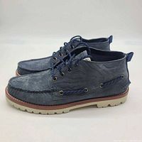 Profile view of both navy chukka boots