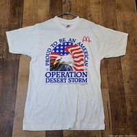 Full view of front of T-shirt hanging on hanger