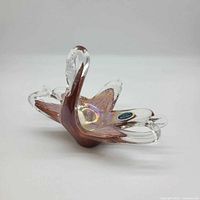 Oblique view of amber-clear Murano glass swan showing sticker