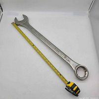Full view of wrench beside tape measure showing approx 25 in length