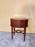 Front view of oval cherry end table
