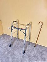 Walker and cane full view against wall