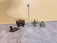 Group shot of all five items lined up on carpet against wall