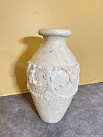 Front view of cream fibrestone vase showing full height and rough relief band