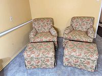 Pair of floral armchairs with ottomans full view