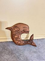 Front view of carved orca showing formline designs