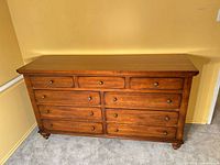 front view of 9-drawer amber wood dresser