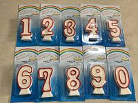 Retail-packaged sample candles 1-9 and 0 showing style and packaging