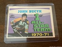 Front of card in plastic holder showing player image, name, 1st All-Star Team banner and 1970-71 season