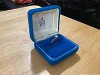 Ring in open blue Birks box showing high solitaire mount